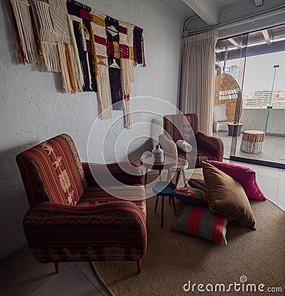 Colorful chairs and decor inside room at Selina hostel, pile of cushions on the floor Editorial Stock Photo