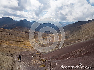 Local walks up the path to the seven colors mountain carrying bag Editorial Stock Photo