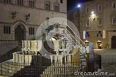 Night view of Perugia monumental fountain and Priori palace at night Stock Photo