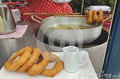 Peruvian Food, Preparing Picarones, Peruvian classic dessert, picarones with honey. Stock Photo