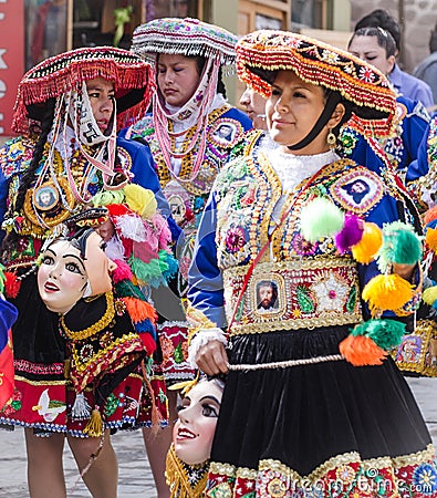 Peruvian ladies dressed in elaborate costumes walking to religious fesitval Editorial Stock Photo