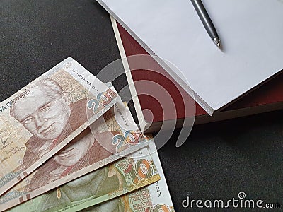 peruvian money, books and pen on black background Stock Photo