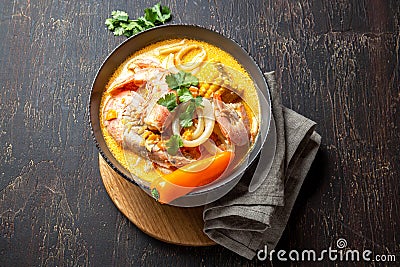 Peruvian seafood soup Chupe de Camarones in gray bowl, top view Stock Photo