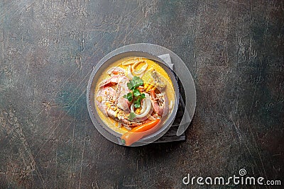 Peruvian seafood soup Chupe de Camarones in gray bowl, top view Stock Photo