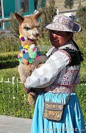 Peruvian woman portrait carrying small baby lama Editorial Stock Photo