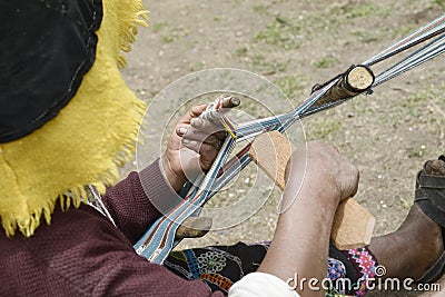 Peruvian woman in traditional clothing weaving cloth Stock Photo