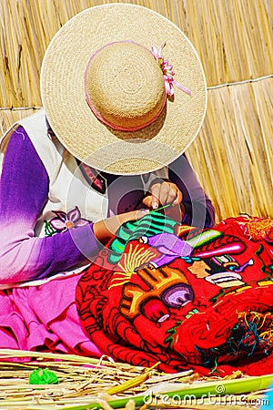 Peruvian women knitting traditional handmade craft in Uros Island, Puno, Peru Editorial Stock Photo