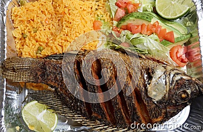 Pescado Frito, a Mexican dish with fried tilapia, yellow rice and salad Stock Photo