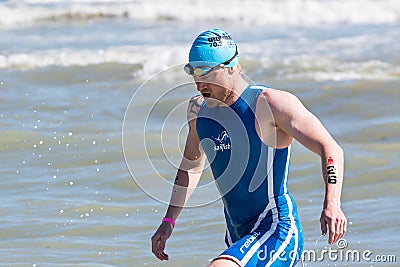 Arrival of the first athletes at the end of the swimming test at Ironman 70.3 in Pescara Editorial Stock Photo