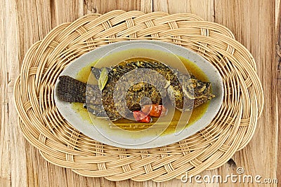 Pesmol Ika Nila, Tilapia Yellow Curry, Popular Curry Recipe made from Fried Fish in West Java, Indonesia Stock Photo