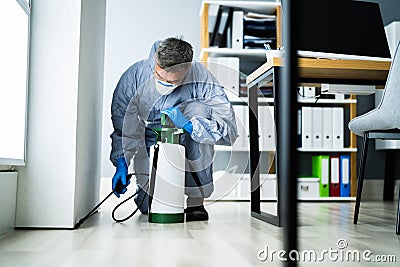 Pest Control Exterminator Man Spraying Pesticide Stock Photo