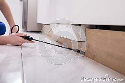 Pest Control Worker Spraying Pesticide On Wooden Cabinet Stock Photo