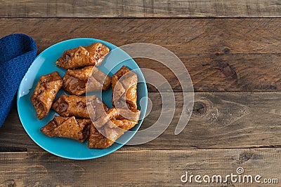 PestiÃ±os. Typical sweet of Christmas and Easter. Carnival fried sweets in blue plate on wooden background Stock Photo