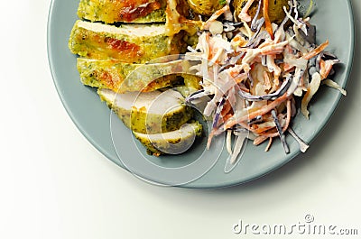 Pesto and mozzarella chicken breast fillet with herby baby potatoes and creamy coleslaw salad Stock Photo
