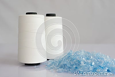PET bottle flake or Plastic bottle crushed & Raw White Polyester FDY Yarn spool Stock Photo
