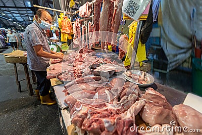 Butcher preparing meats at morning wet market Editorial Stock Photo