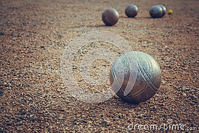 Petanque balls on a sandy pitch with other metal ball Stock Photo