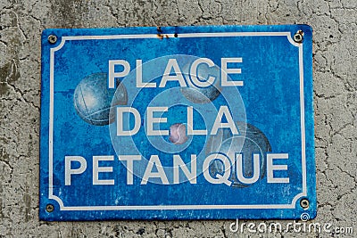 Petanque boule sign in washed out blue Stock Photo