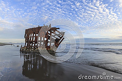 Waves coming up to the old shipwreck in Oregon. Stock Photo