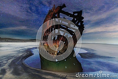 Peter Iredale Shipwreck Under Starry Night Sky along Oregon coast Stock Photo