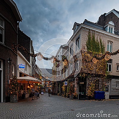 Petit Paris in the Koestraat, a street with up level restaurants in Maastricht, decorated and illuminated with lights Editorial Stock Photo