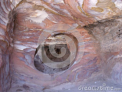 Window of a tomb carved into the reddish rock of the mountain of Petra, Jordan Editorial Stock Photo