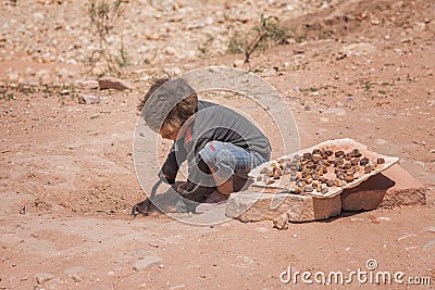 Little boy, jordanian sells souvenirs. Childrens work. Genre photography in Petra Jordan Editorial Stock Photo