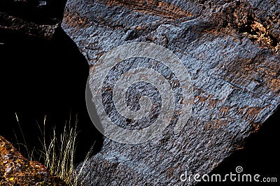 A petroglyph is an image created by removing part of the surface of a rock by incising, chipping, carving a form of rock art. Editorial Stock Photo