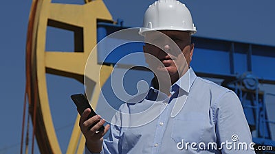 Petroleum Engineer Working in Extracting Oil Industry Talking With Mobile Phone Stock Photo