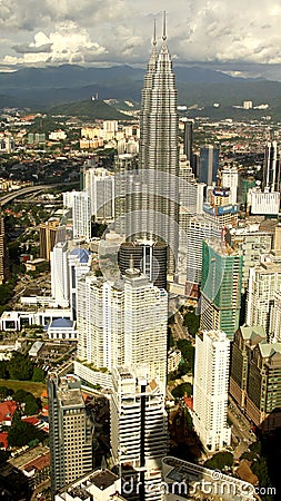 Petronas Twin Towers inmidst Kuala Lumpur skyline Stock Photo