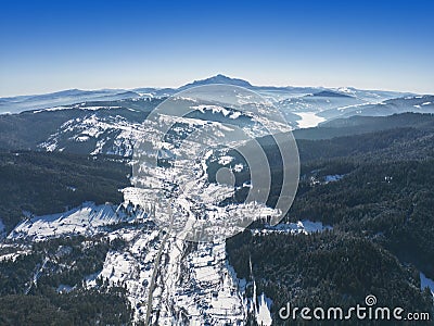 Petru Voda village and Ceahlau mountain in Romania, winter Stock Photo