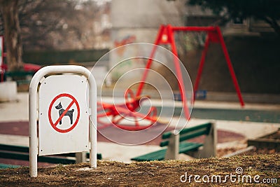 Pets no pooping sign in front of children playground Stock Photo