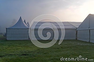 Marquees in the morning mist. Stock Photo