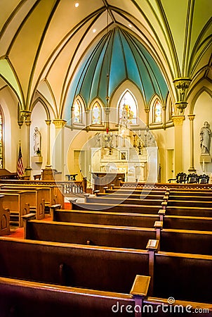 Pews and interesting architecture in St. Peter's Roman Catholic Stock Photo