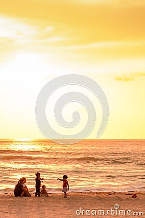 Thai fisherman family relaxing on the sunset beach, Ban Nam Khem, Phang Nga, Thailand Editorial Stock Photo