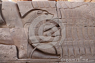 pharaonic relief carvings (lion preys on the hands of pharoh's enemies) in Kom ombo temple Stock Photo