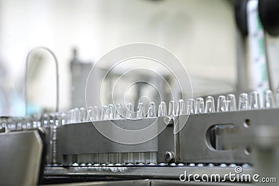 Pharmaceutical industry. Production Line. Machine conveyor with glass bottles, ampoules in a factory. Fill bottles and Stock Photo