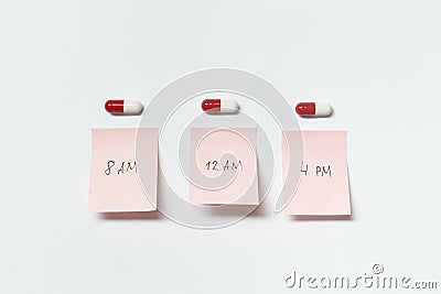 Pharmaceutical pills and medication time notes. Stock Photo