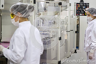 Pharmaceutical Production Line Workers Stock Photo