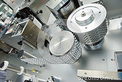 Pharmaceutical tablet pill production. blistering packing machine Stock Photo