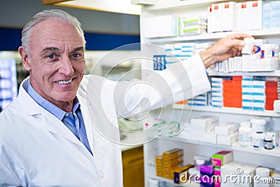 Pharmacist checking a bottle of drug Stock Photo