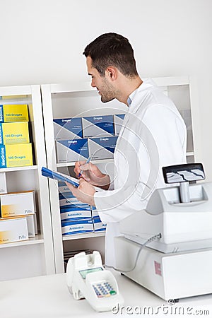 Pharmacist checking drugs Stock Photo