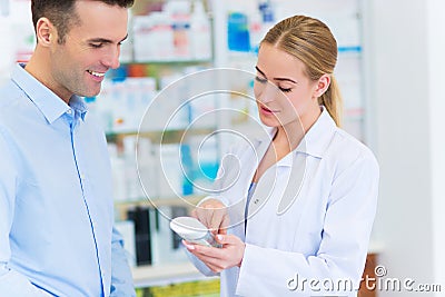 Pharmacist and client at pharmacy Stock Photo