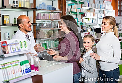 Pharmacist helping customers Stock Photo