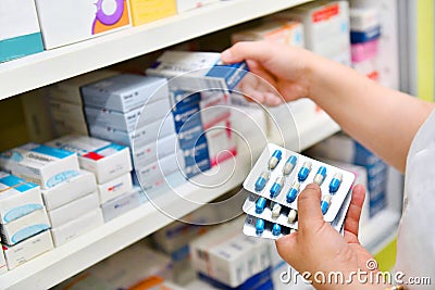 Pharmacist holding medicine box and capsule pack Stock Photo