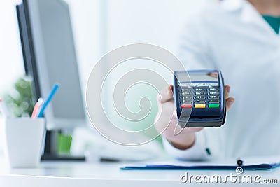 Pharmacist holding a payment terminal Stock Photo