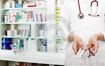 Pharmacist holding pills Stock Photo