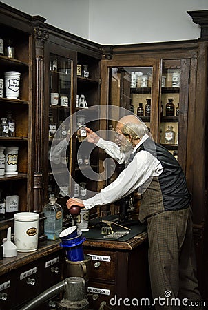 Pharmacist in an old pharmacy Editorial Stock Photo