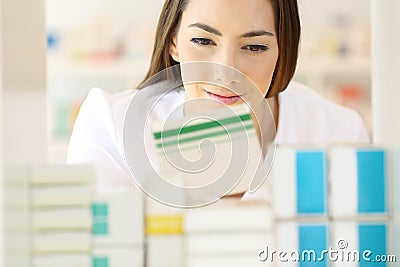 Pharmacist searching medicines in a pharmacy Stock Photo