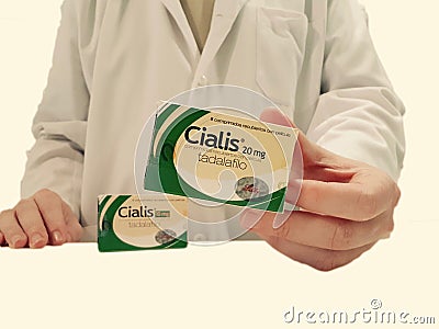 Pharmacist showing a box of Cialis Editorial Stock Photo